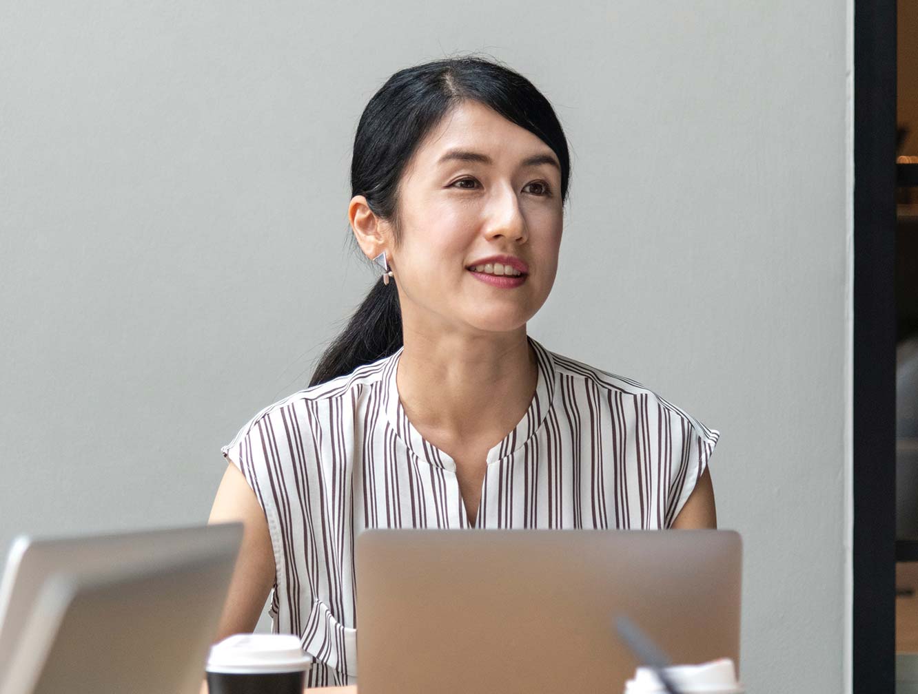 Woman Sitting behind Laptop